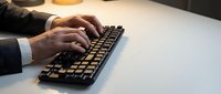 Professional businessman hands typing on mechanical keyboard at modern office desk workspace for productivity and business communication.