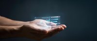 Male hand holding glowing digital holographic interface with data analytics charts and graphs on dark background for technology and business concepts.