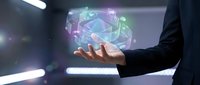 Businessman in dark suit holding glowing holographic globe with digital network connections and data visualization, representing global technology, innovation, and digital transformation.