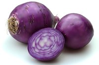 Fresh purple onions with sliced cross-section showing layered rings, isolated on white background for culinary and cooking designs.