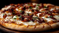 Fresh baked pizza with crispy bacon, melted mozzarella cheese and herbs on dark wooden board, close up view of traditional Italian cuisine.