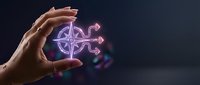 Hand holding glowing purple compass symbol with digital light effects on dark background for navigation and direction concepts.