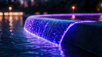 Illuminated water feature with cascading purple and blue lights creating magical nighttime ambiance, flowing water catching reflections in dark pool setting.