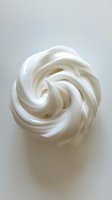 Swirled white meringue or whipped cream in spiral pattern on light background, showcasing soft peaks and smooth texture for culinary and food photography use.