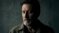 Mature Caucasian man with gray beard and weathered face in dramatic lighting against dark textured background for character portraits and storytelling concepts.