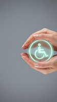 Caucasian woman's hands holding glowing glass sphere with wheelchair accessibility symbol, representing disability support, inclusive care, and social responsibility initiatives.