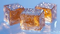 Glowing amber jelly cubes with sparkling sugar crystals on blue surface, soft focus macro photography creates magical food art effect for dessert styling.