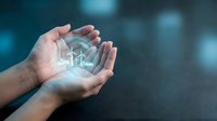 Hands protecting glowing wind turbine hologram symbolizing renewable energy conservation and sustainable power technology for environmental protection.