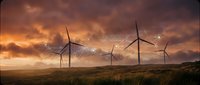 Wind turbines generating renewable energy on grassy hillside during dramatic sunset with orange and purple clouds creating sustainable power landscape.