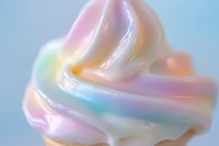 Holographic rainbow swirl cream with iridescent pastel colors creating smooth flowing waves on gradient background for modern design projects.