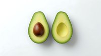 Halved avocado with pit and without pit displayed on white background, isolated for culinary, nutrition, and healthy eating design projects.