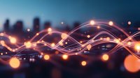 Glowing orange light waves flow across dark cityscape silhouette with bokeh effects creating modern abstract technology and communication concept background.