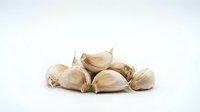 Garlic cloves isolated on white background, ready for culinary design, cooking websites, recipe blogs, food packaging, and restaurant menus.
