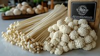 Fresh white enoki and white beech mushrooms arranged on wooden surface with black label, raw organic ingredients for Asian cuisine preparation.