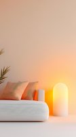 Minimalist living room interior with white sofa, peach cushions and glowing lamp creating warm ambient lighting against neutral wall with palm leaf accent.