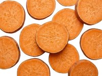 Fresh sweet potato slices scattered on white background, showing vibrant orange flesh texture, isolated for food, nutrition, and healthy eating projects.