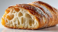 Artisan sourdough bread slice showing airy crumb structure with golden crust, perfect for bakery menus, food blogs, and culinary presentations.
