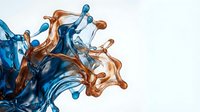 Dynamic blue and orange liquid splash collision creating abstract fluid motion with droplets and waves on white background for creative design projects.