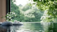 Tranquil infinity pool edge with spa stones and white orchid flowers against lush green forest background, creating serene wellness atmosphere.
