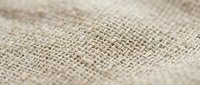 Natural burlap fabric texture with woven fibers in beige and brown tones, close-up macro photography showing detailed textile pattern for rustic design projects.