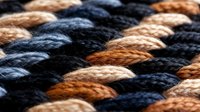 Colorful braided rope texture with alternating dark blue and brown fibers creating geometric pattern for nautical and craft projects.