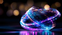 Glowing spiral light trails in blue and pink neon colors against dark background with bokeh effect create magical atmosphere for abstract design projects.