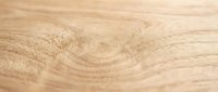 Close-up of natural wood grain texture showing detailed annual rings and organic patterns, suitable for backgrounds, flooring design, and woodworking projects.
