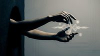 Hands holding glowing white dove symbolizing peace, hope and freedom against dark background for spiritual and conceptual designs.