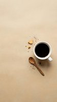 Overhead view of steaming black coffee in white ceramic mug with wooden spoon and scattered coffee beans on neutral beige background, ideal for cafe and beverage marketing.