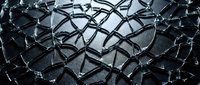 Shattered glass texture with intricate crack patterns on dark background, dramatic macro detail capturing fragmented surface for design and creative projects.