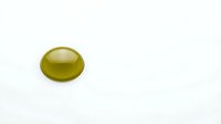 Single green olive oil drop on white background isolated for culinary and cooking design projects.