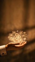 Business hand holding glowing digital technology icons with gears and data symbols representing innovation and digital transformation concepts.
