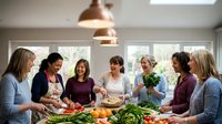 Group of diverse women friends cooking together in modern kitchen preparing healthy meal with fresh vegetables for social gathering and bonding experience.