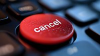 Red cancel button with water drops on black keyboard, dramatic macro photography showing texture and reflection. For business and technology concepts.