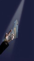 Business hand reaching for glowing upward arrow chart against dark blue background symbolizing growth success and achievement in corporate finance.