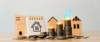 Real estate investment growth concept with wooden house models, stacked coins, and calculator on neutral background for financial planning presentations.