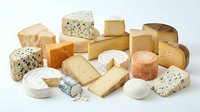 Assorted gourmet cheese collection featuring hard, soft, blue and aged varieties isolated on white background for culinary and food design projects.