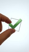 Hand holding green checkmark in checkbox on white background for business approval and task completion concepts.