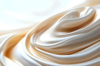 Smooth flowing waves of creamy white and beige satin fabric create elegant abstract curves and folds against soft background lighting for luxury designs.