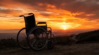 Silhouette of empty wheelchair against dramatic golden sunset sky with clouds, symbolizing hope, recovery, and accessibility for healthcare and wellness campaigns.