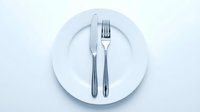 Elegant table setting with white plate, fork and knife on neutral background, ready for restaurant, catering, dining and food service design projects.