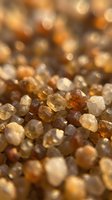 Macro shot of raw brown and golden sugar crystals with shallow depth of field, showcasing crystalline texture and light refraction for confectionery, food production, and culinary design projects.