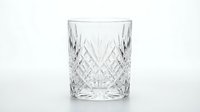 Crystal cut glass tumbler with diamond pattern isolated on white background for luxury drinkware and barware designs.
