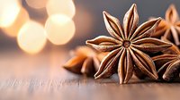 Star anise pods on rustic wooden surface with soft golden bokeh lights in background, creating warm aromatic spice composition for culinary and holiday designs.