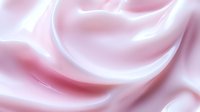 Soft pink silk fabric with elegant flowing curves and smooth texture creating luxurious waves for fashion and textile design backgrounds.