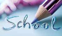 Purple wooden pencil writing word school in blue on white paper with soft focus background, macro photography for education and learning concepts.