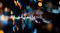Businessman finger touching digital financial chart with glowing data points and bokeh lights background for investment analysis and market research.