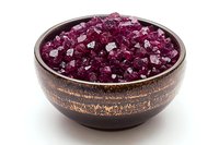 Pink Himalayan salt crystals in rustic ceramic bowl against white background, natural mineral seasoning for gourmet cooking and spa treatments.