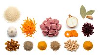 Fresh cooking ingredients and spices arranged on white background including diced meat, vegetables, herbs and seasonings for culinary preparation and recipes.