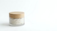 Natural skincare cream jar with wooden lid on white background for cosmetic product packaging and beauty brand marketing.